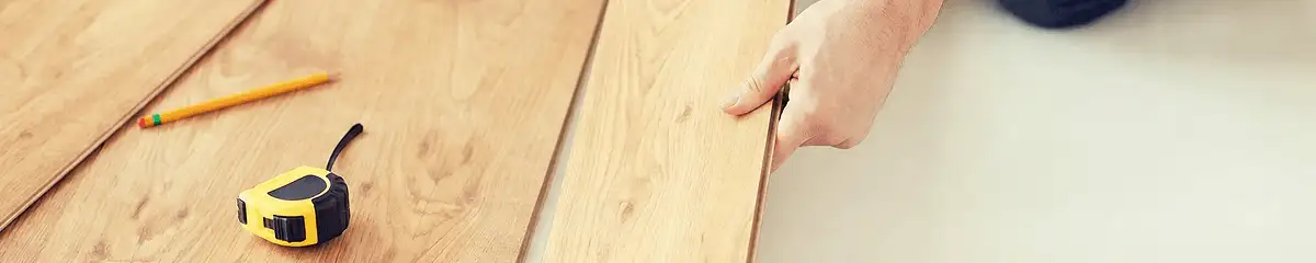 A professional installing wood flooring in Jacksonville, FL