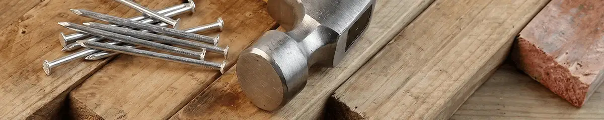 Hammer and nails on hardwood flooring boards in Jacksonville, FL