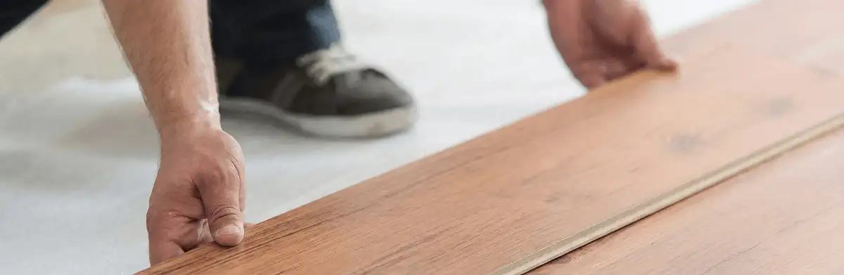 A professional installing laminate flooring in Jacksonville, FL